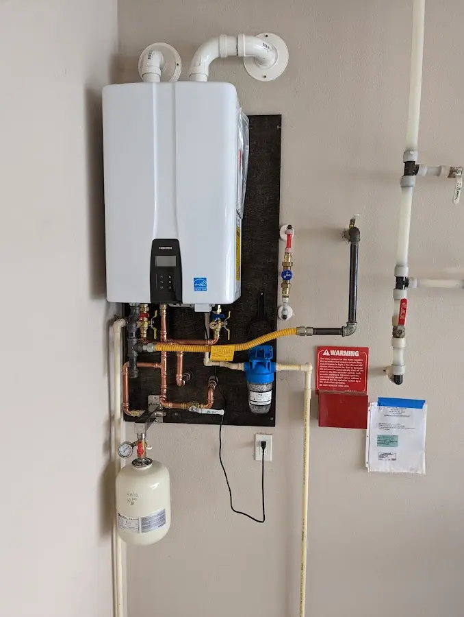 Professional plumber installing copper piping in a Wheaton home